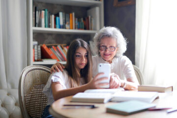 aging in place home help from granddaughter looking at phone looking for home safety upgrades